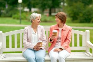 two women on a bench discussing chemical dependency counseling